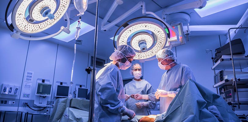 Three surgeons in an medical operating room